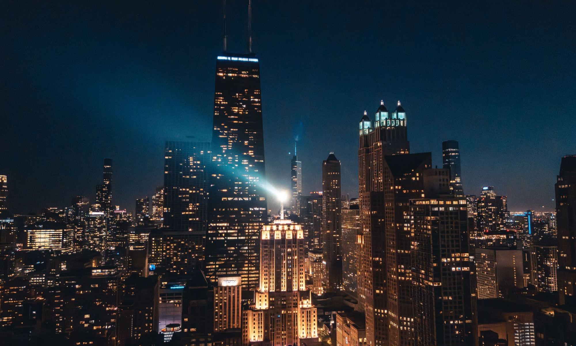 The Chicago skyline at night, with the John Hancock Center lit from below